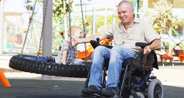 Father enjoying time with his son and using an Aquila custom wheelchair cushion